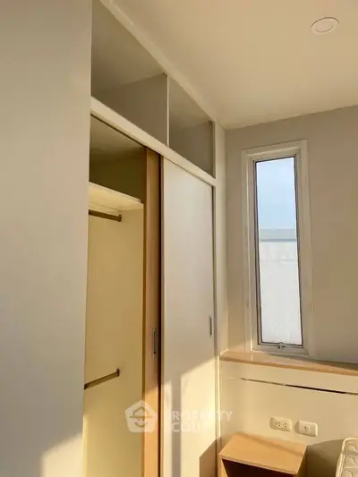 Bright bedroom with built-in closet and window view