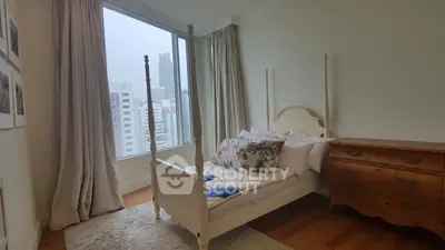 Charming bedroom with city view, featuring elegant four-poster bed and vintage dresser.