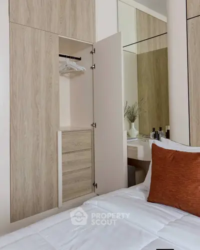 Modern bedroom with built-in wardrobe and cozy bedding