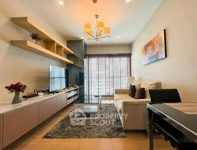 Modern living room with stylish decor and natural light, featuring a cozy sofa and elegant shelving.