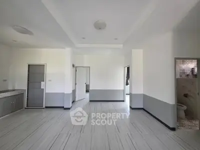 Spacious open-plan living area with modern design and sleek flooring