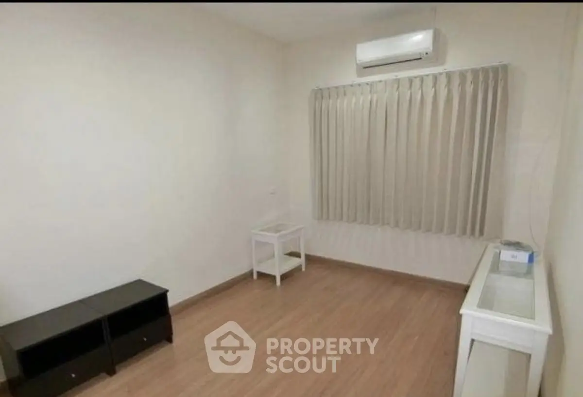 Minimalist unfurnished room with air conditioning and wooden flooring