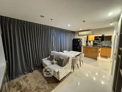 Modern open-plan living room with elegant kitchen and cozy seating area