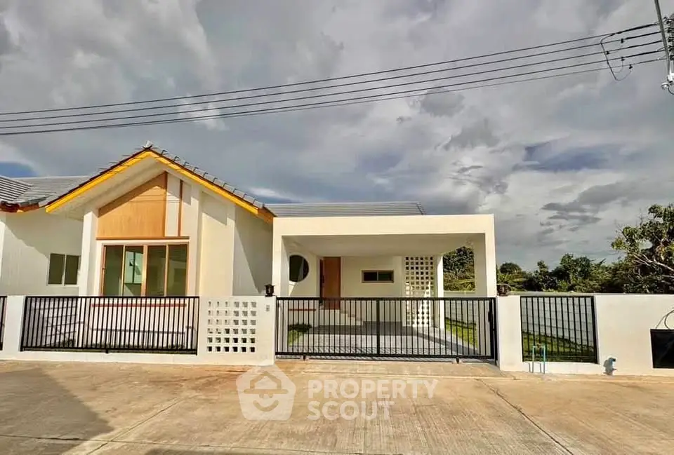 Modern single-story house with spacious driveway and contemporary design.