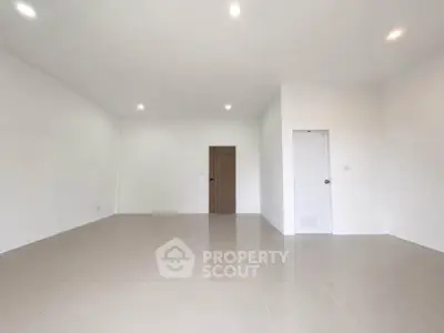Spacious empty room with white walls and tiled floor, perfect for customization.