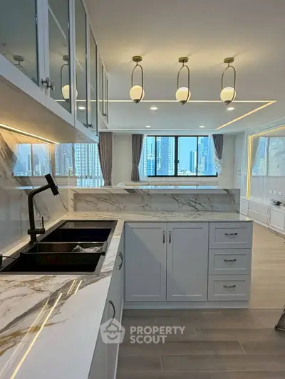 Luxurious modern kitchen with marble countertops and city view