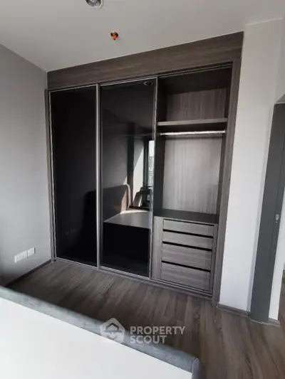 Modern bedroom with sleek built-in wardrobe and stylish wood flooring