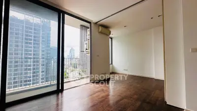 Spacious modern apartment with balcony and city view, featuring sleek wooden flooring and large windows.