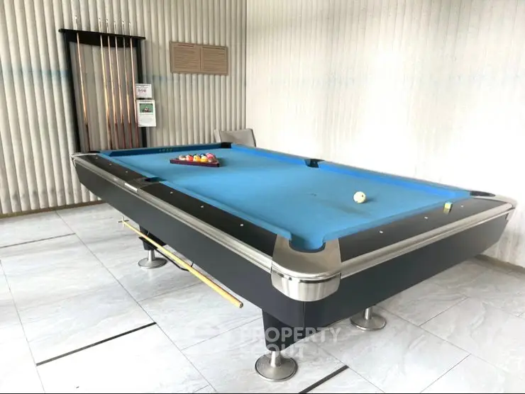 Modern billiard room with sleek pool table in luxury apartment building