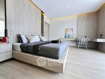 Modern bedroom with sleek design and stylish decor, featuring a cozy bed and elegant furnishings.