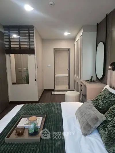 Luxurious modern bedroom with elegant decor and plush bedding in a stylish apartment.