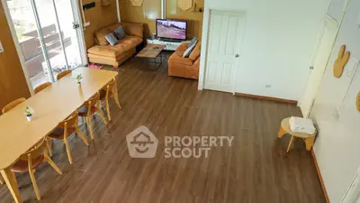 Spacious living room with modern furniture and large dining table, perfect for entertaining.