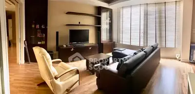 Spacious living room with modern furniture and large windows offering ample natural light.