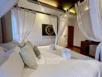 Luxurious bedroom with elegant canopy bed and soft lighting, perfect for relaxation and comfort.