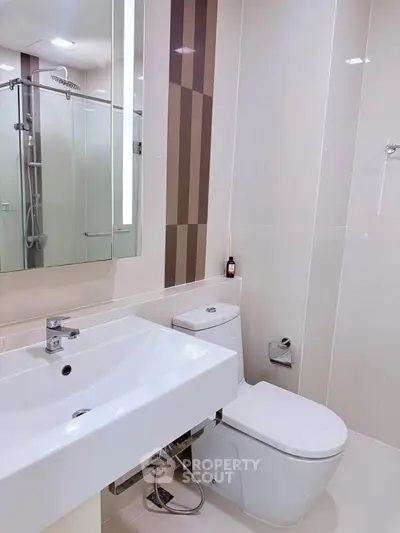 Modern bathroom with sleek fixtures and glass shower enclosure