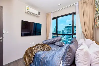 Modern bedroom with city view, featuring stylish decor and large windows.