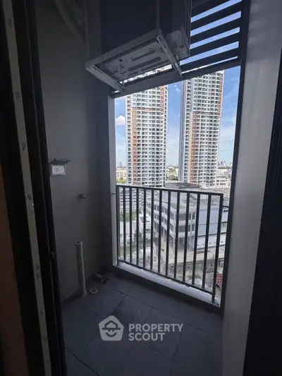 Compact balcony with city view in modern high-rise apartment
