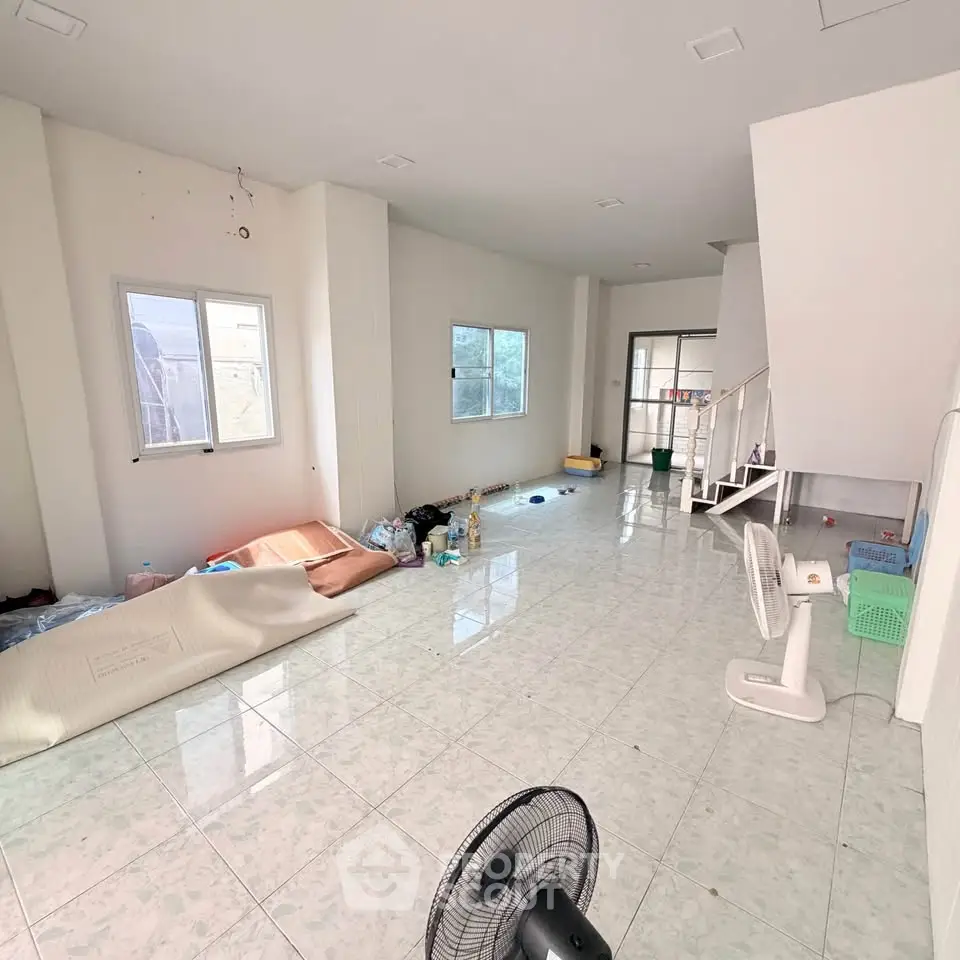 Spacious unfurnished living room with tiled floor and natural light