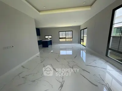 Spacious modern living room with marble flooring and large windows