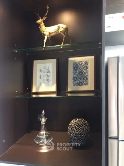 Elegant kitchen shelf with decorative items and modern fridge