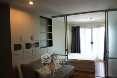 Modern studio apartment with sliding glass doors and natural light