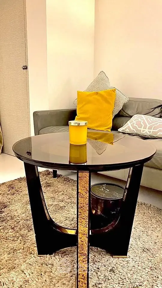 Stylish living room with modern glass coffee table and cozy sofa
