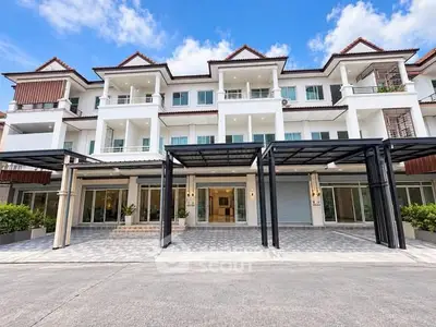 Stunning modern townhouse exterior with spacious balconies and elegant entrance.