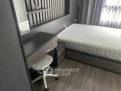 Modern bedroom with sleek design, featuring a comfortable bed and stylish study area.