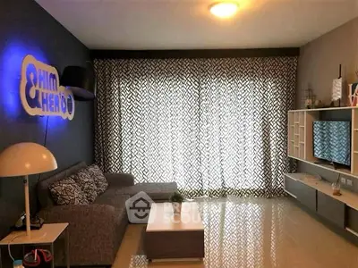 Modern living room with stylish decor and large window curtains