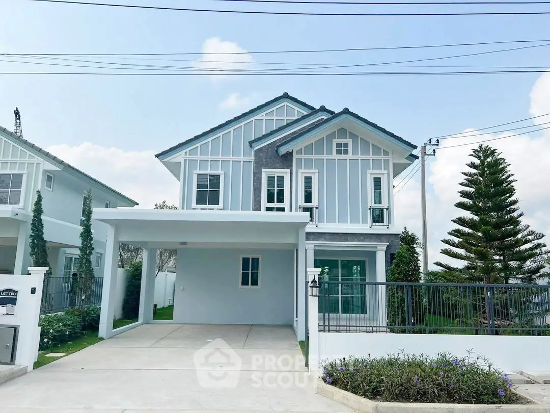 Charming two-story house with modern design and spacious driveway in a serene neighborhood.