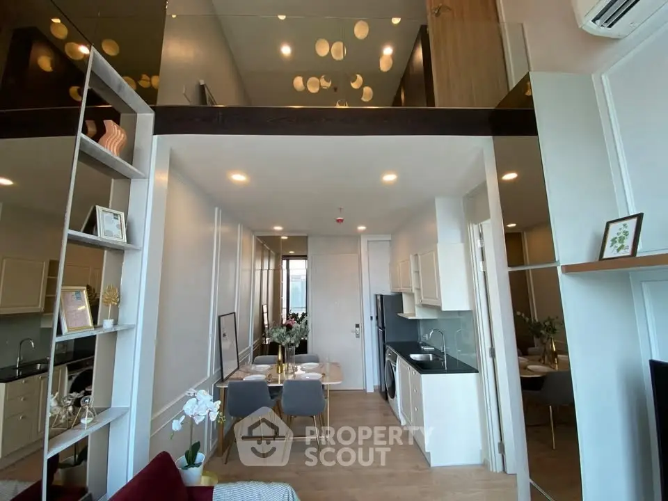 Modern open-plan living and dining area with stylish decor and high ceilings