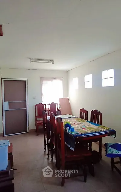 Spacious dining area with natural light and elegant wooden furniture.