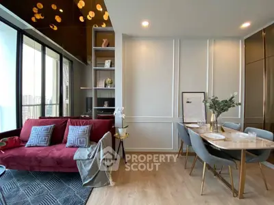 Modern living room with elegant dining area and city view, featuring stylish decor and cozy ambiance.