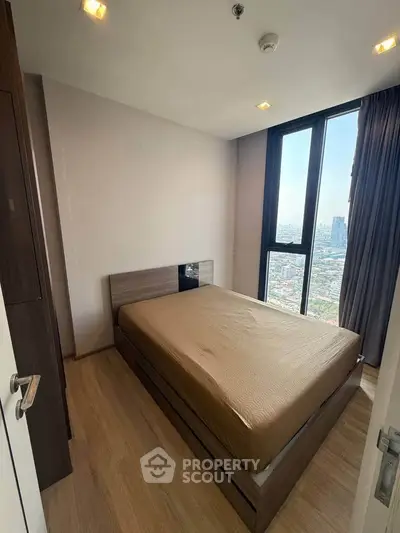 Modern bedroom with city view and sleek wooden flooring