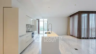 Luxurious modern kitchen with marble accents and open layout in high-rise apartment.
