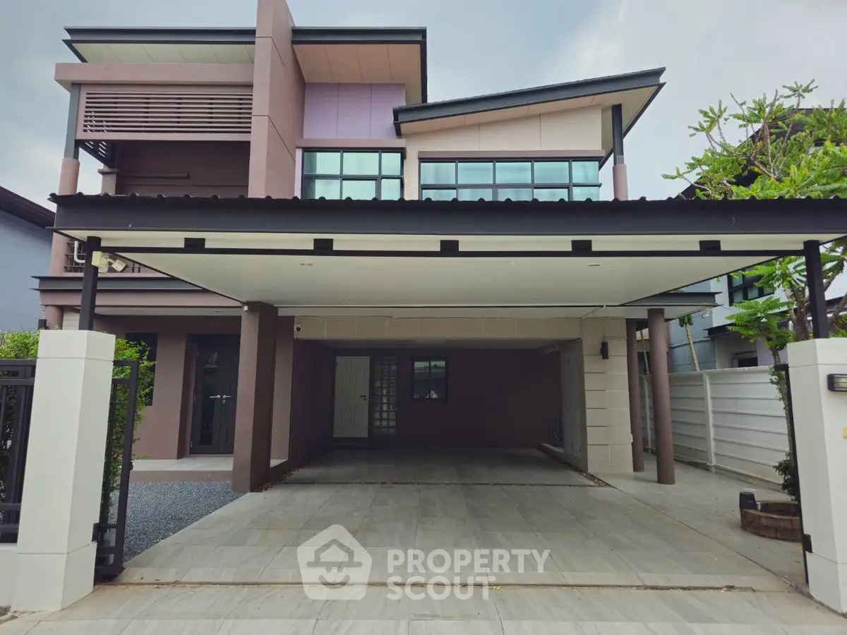 Modern two-story house with spacious carport and contemporary design.
