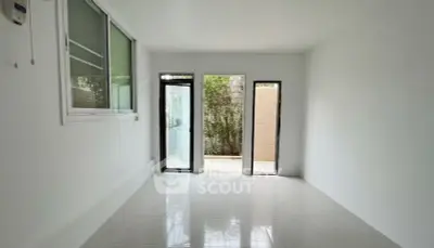 Bright minimalist room with large windows and garden view