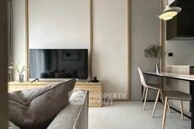 Modern living room with sleek TV setup and stylish dining area