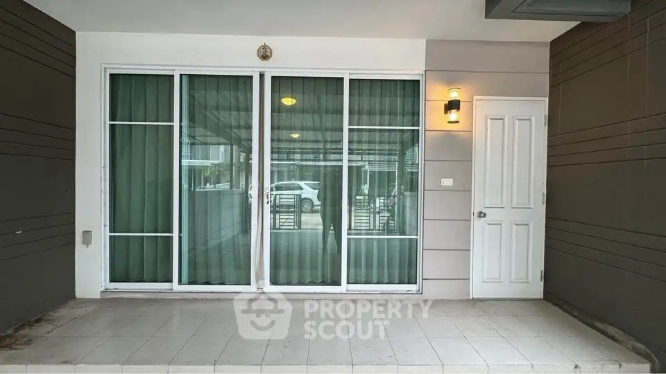 Modern entrance with sliding glass doors and stylish lighting
