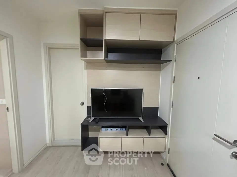 Modern living room with sleek TV unit and ample storage space