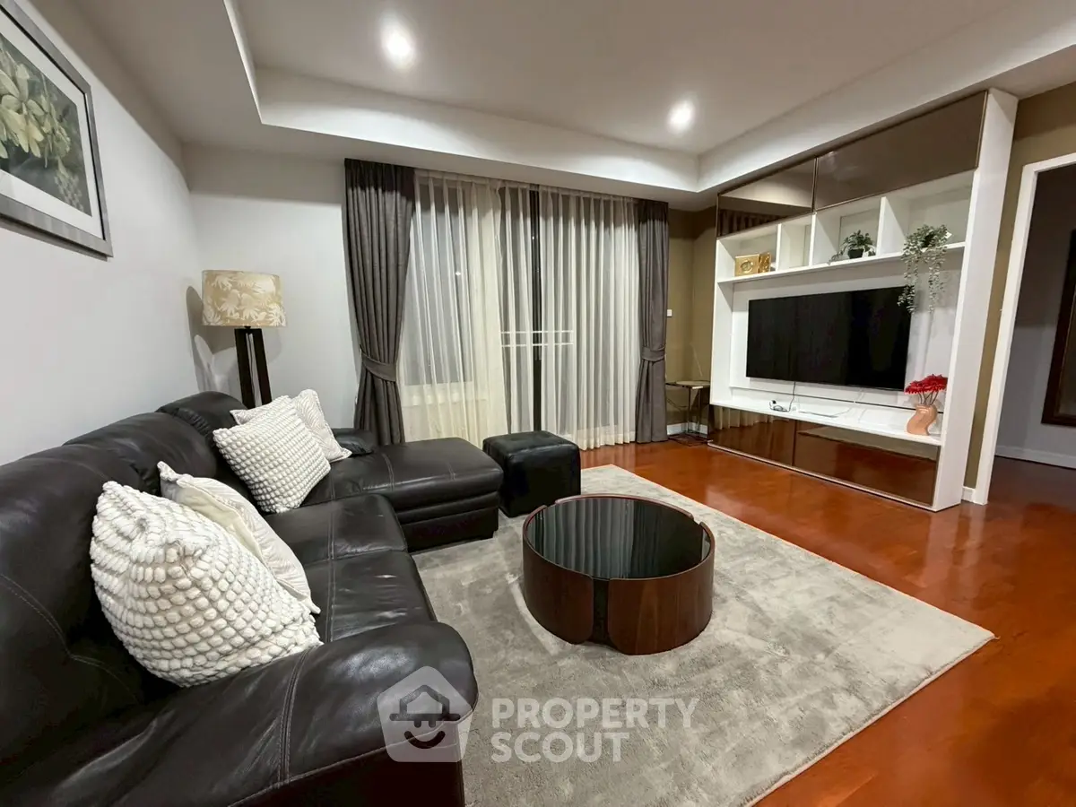 Elegant living room with leather sofa, modern decor, and large TV unit