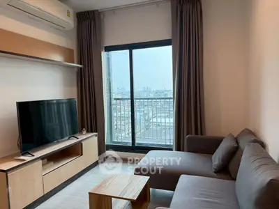 Modern living room with city view, featuring a cozy sofa and entertainment unit.