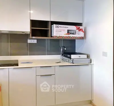 Modern kitchen with sleek cabinetry and Electrolux microwave, ideal for contemporary living.