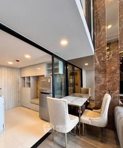 Modern open-layout kitchen and dining area with sleek design and ample natural light.