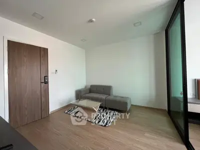 Modern minimalist living room with sleek grey sofa and stylish coffee table