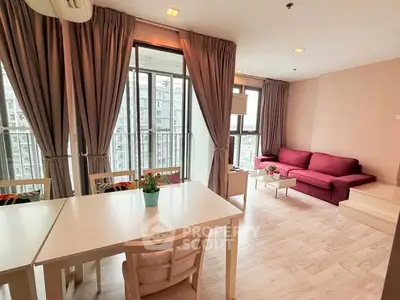 Spacious living room with modern decor and large windows offering city views.