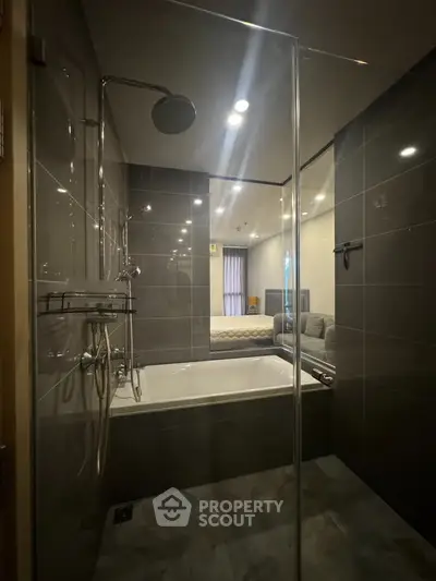 Modern bathroom with sleek design and glass shower enclosure in luxury apartment.