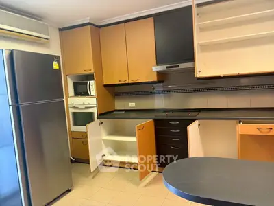 Spacious kitchen with modern appliances and ample storage in a stylish apartment.