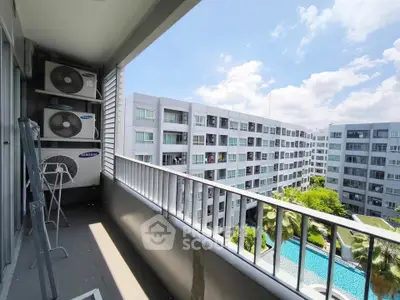 Modern apartment balcony with pool view and air conditioning units