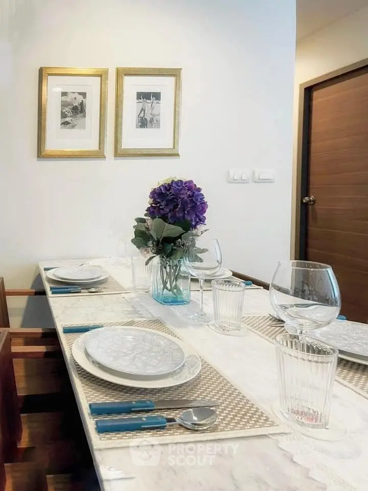Elegant dining area with stylish table setting and floral centerpiece in modern home.